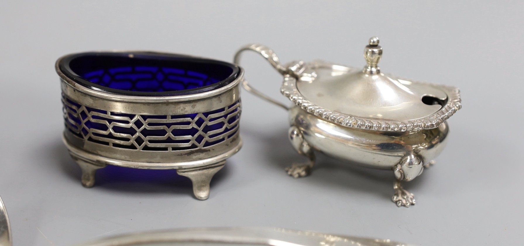 A George V silver sauce boat, Chester 1911, together with four silver condiments, a Georgian silver sauce ladle by William Bateman and four other items of silver cutlery.